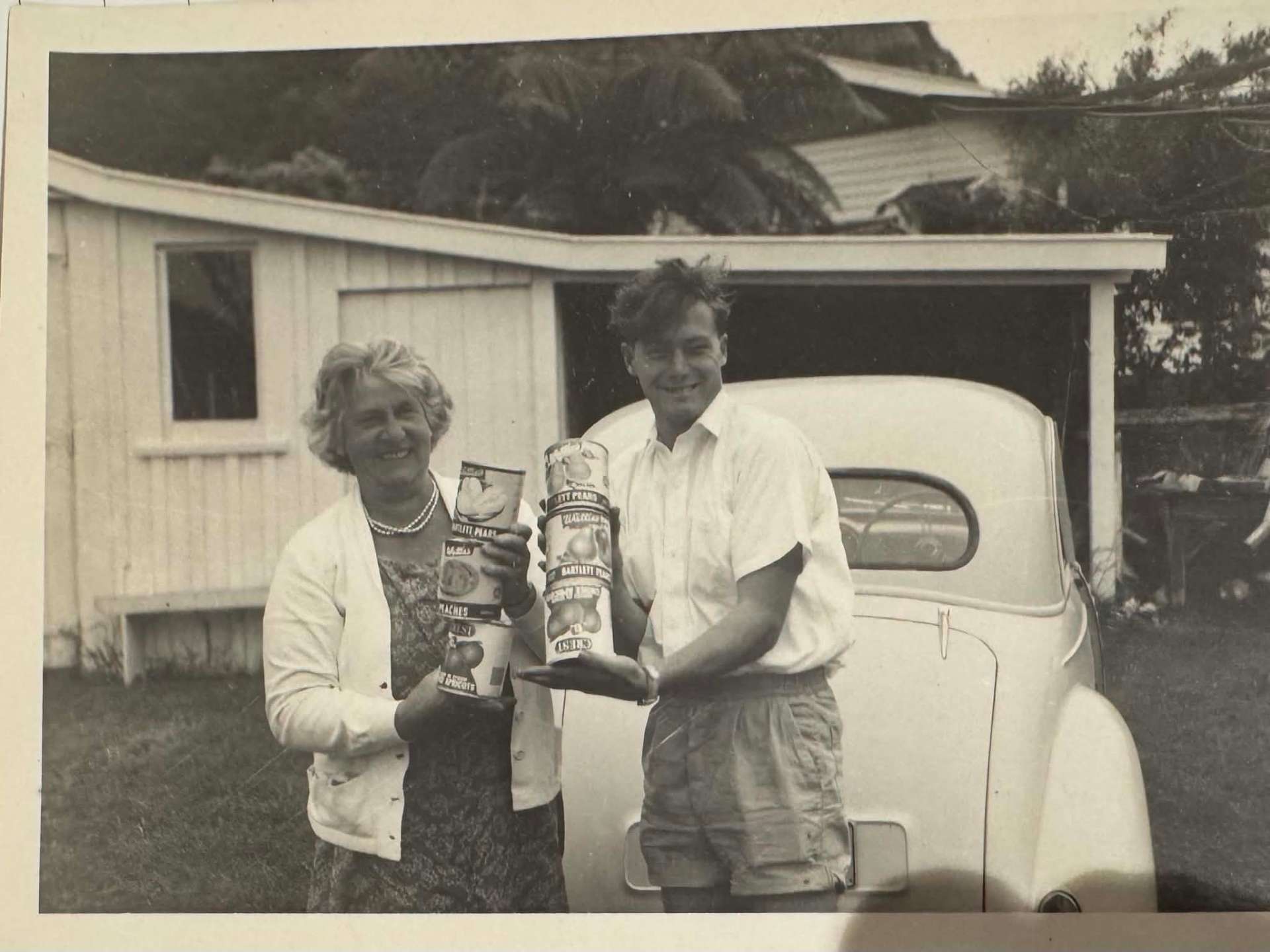 Original photo before FixPix restoration — A proud haul by the car — brought back in full colour