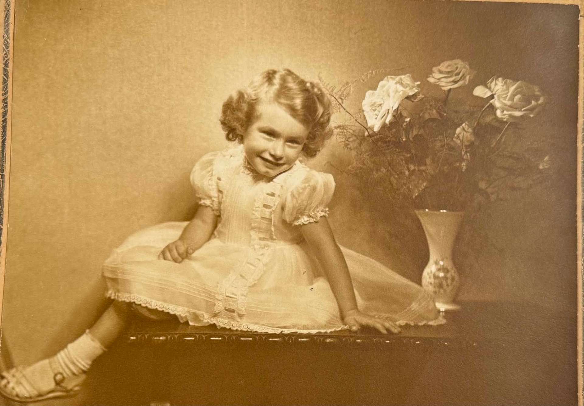 Restored still — A sepia studio portrait, softly brought to life
